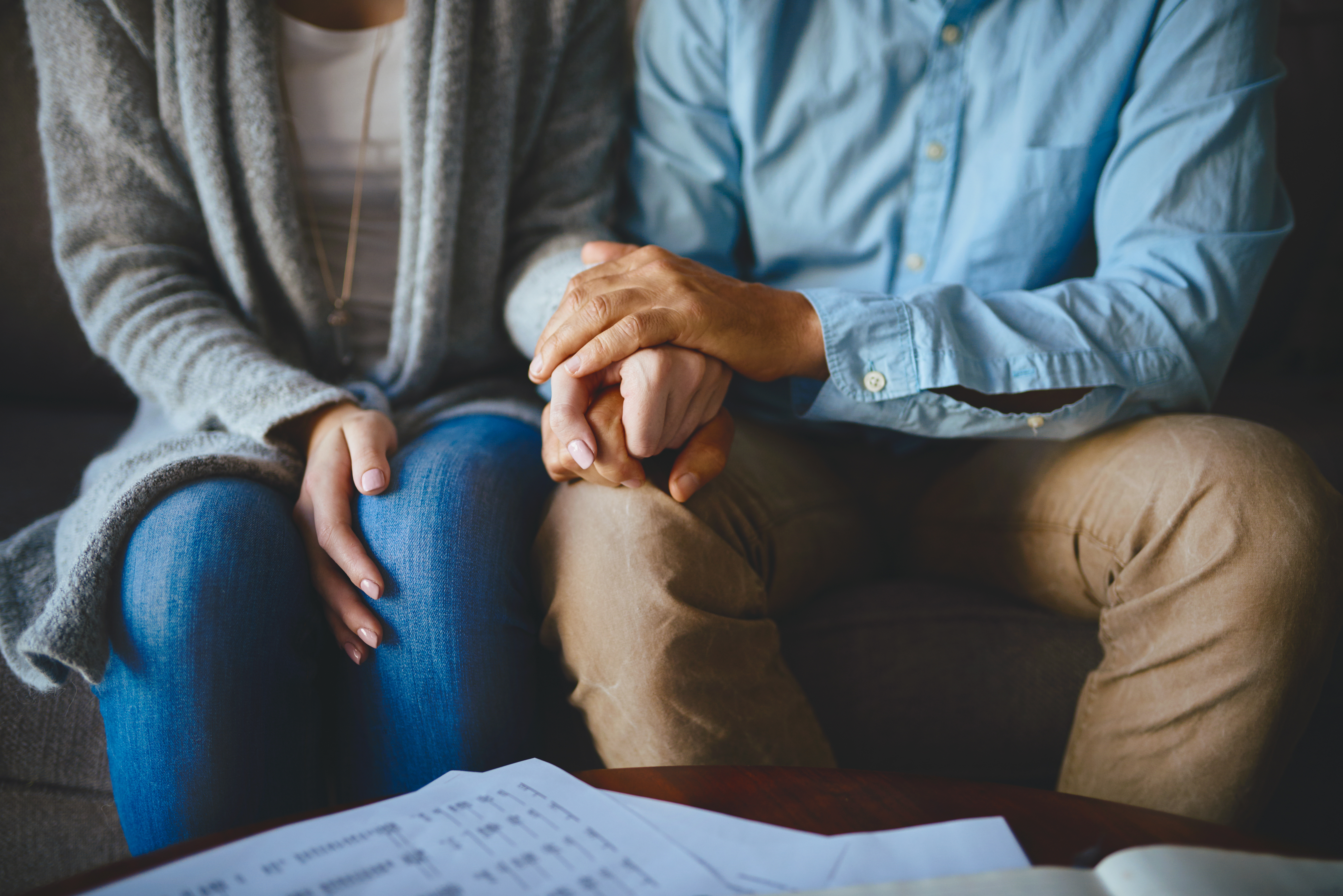 Closeup shot of a couple holding hands in comfort